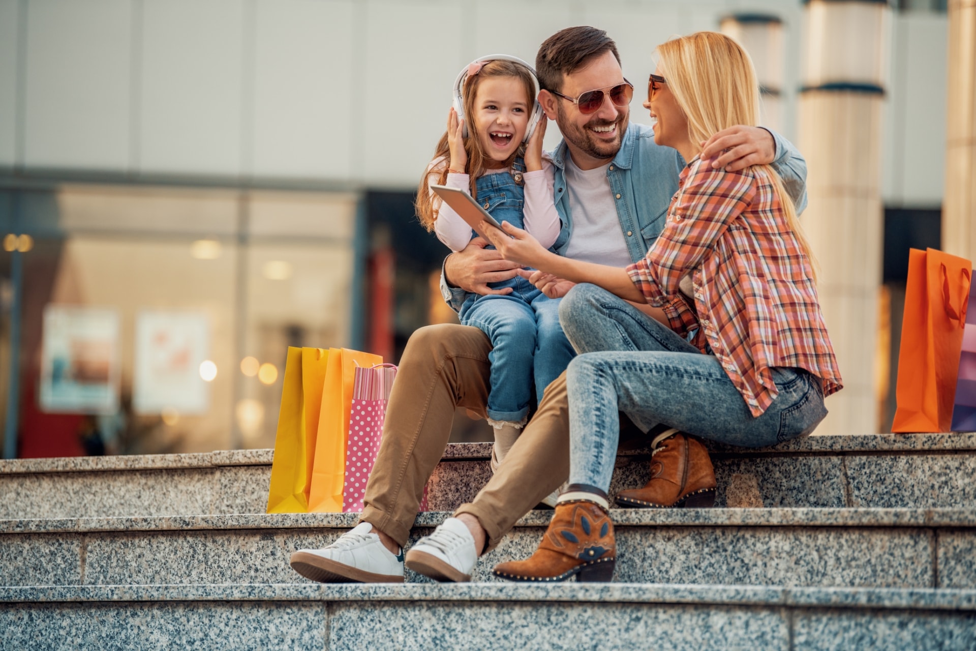 Family sitting on steps at shopping center